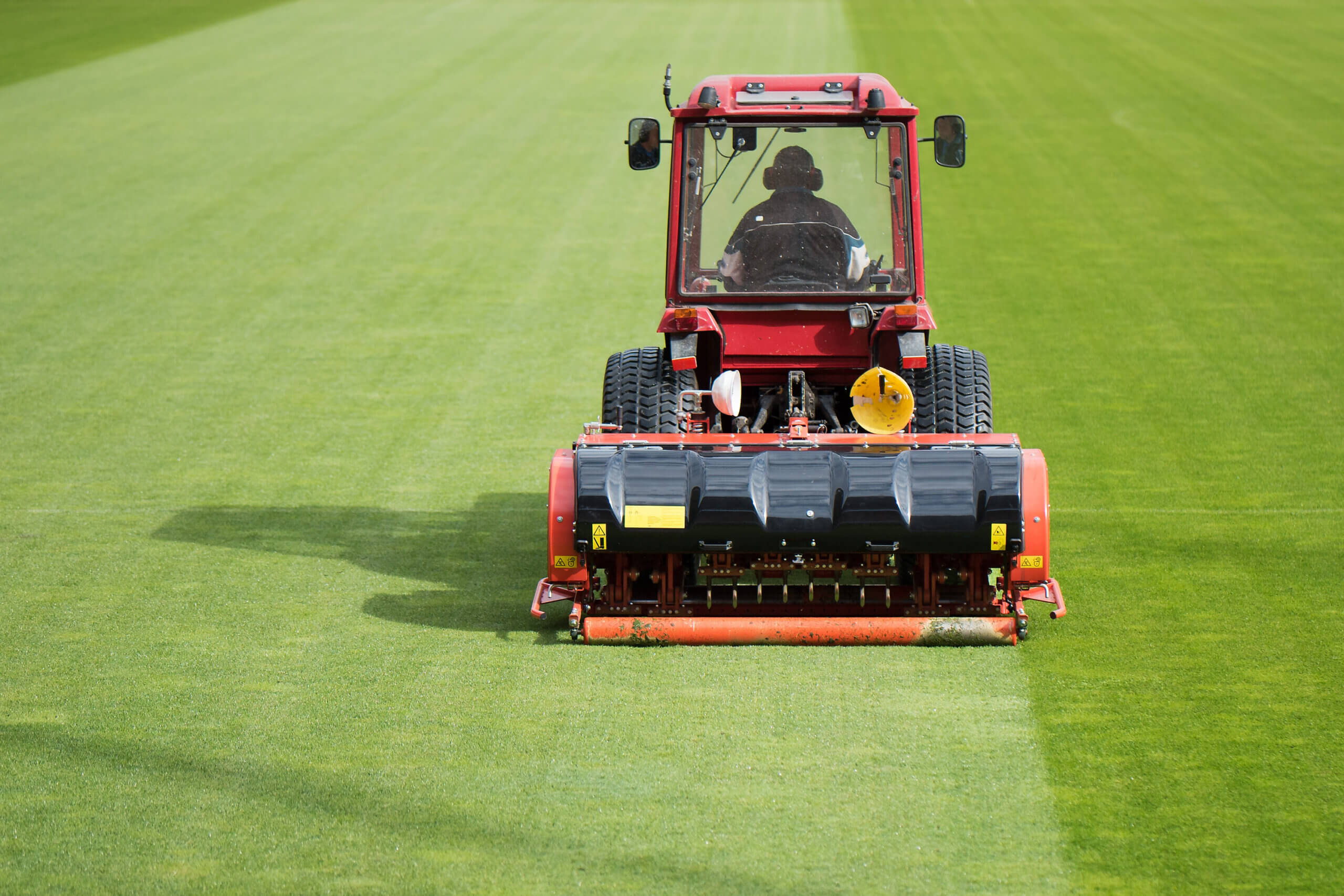 landscaper in tractor equipment at work